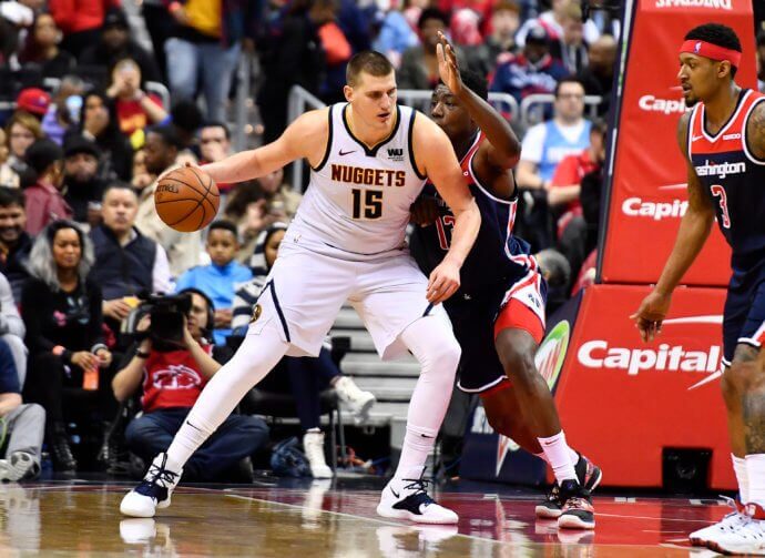 Denver Nuggets center Nikola Jokic dribbles as Washington Wizards center Thomas Bryant defends at Capital One Arena