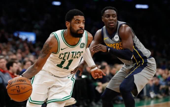 Boston Celtics guard Kyrie Irving (11) drives the ball against Indiana Pacers guard at TD Garden