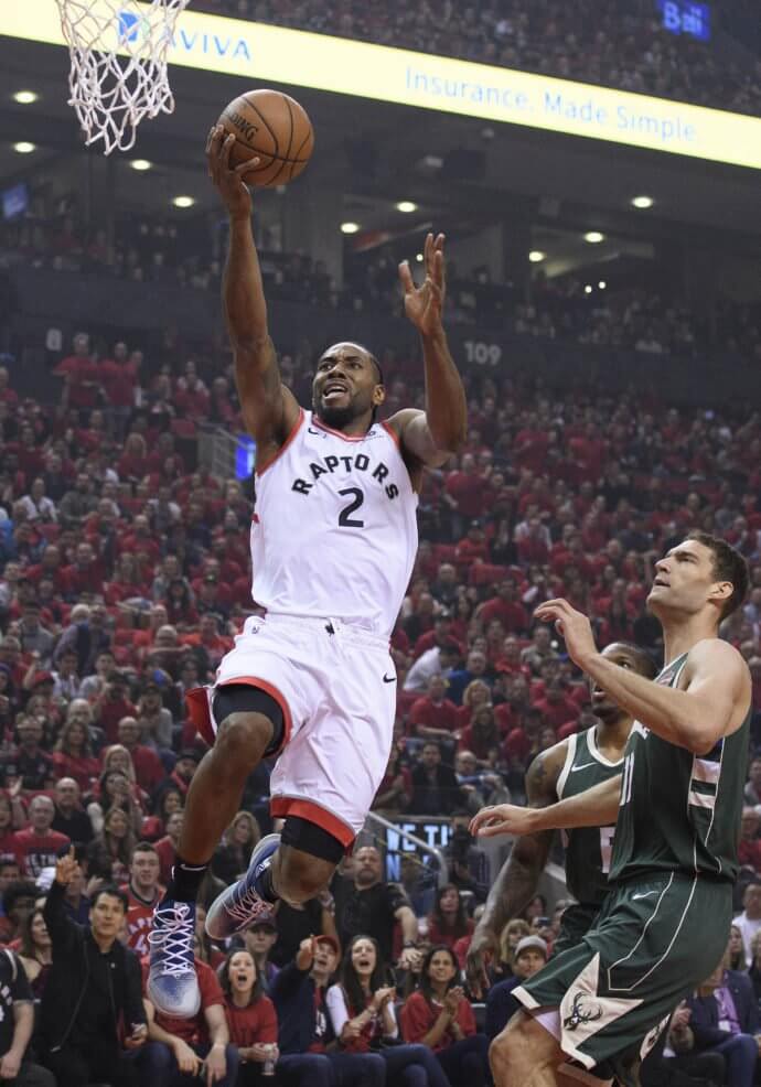 Toronto Raptors forward Kawhi Leonard (2) shoots the ball past Milwaukee Bucks center Brook Lopez (11) at Scotiabank Arena