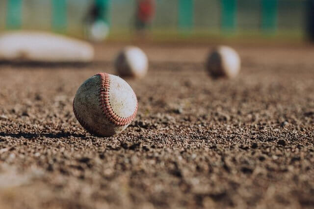 Close-up of a baseball on a dirt field