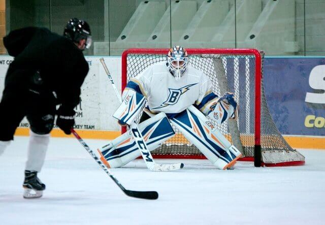 Hockey goalie blocking a shot