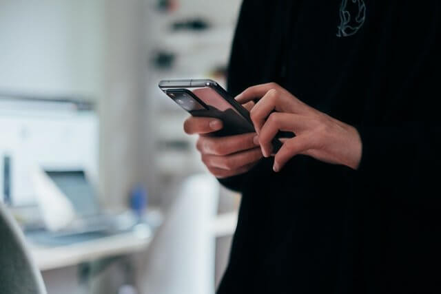 Woman using a sports betting mobile app