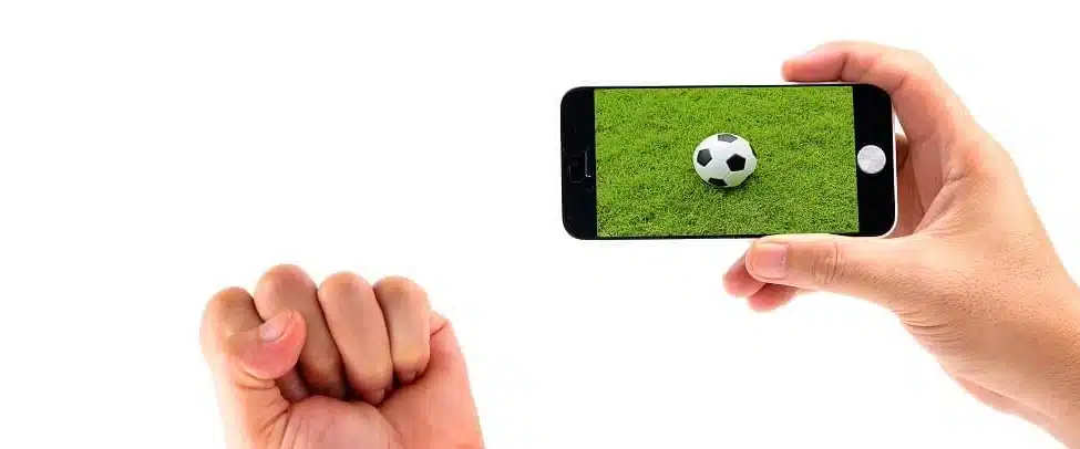 Hands holding a phone showing a soccer ball on the screen